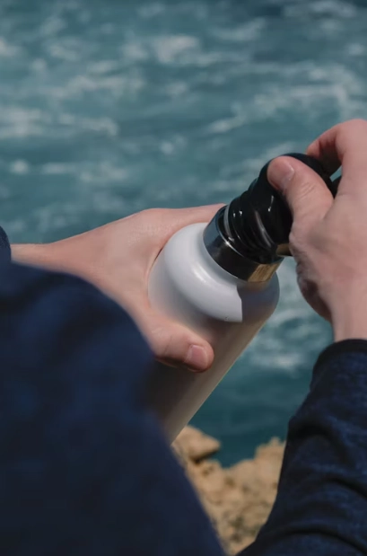 people hoiding white bottle